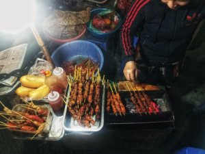 eating cheap street food, banh mi, in Hanoi Old Quarter
