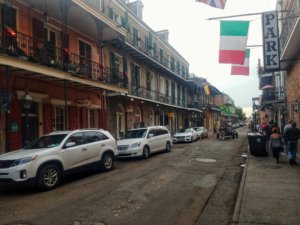 Side street in the New Orleans French Quarter with few people and a horse carriage