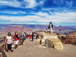 tourists posing for pictures at the popular South Rim viewing area of the Grand Canyon