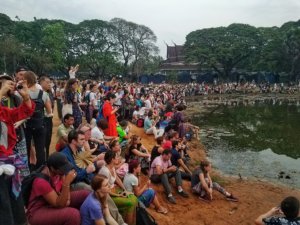 crowds of tourists waiting for sunrise at the world famous Angkor Wat