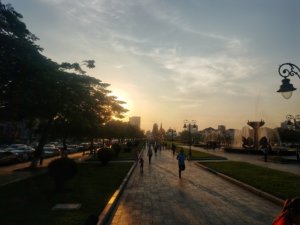 Runners in Independence Park at sunset in Phnom Penh Cambodia