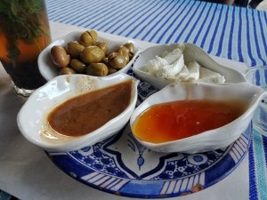 goat cheese olives and glass of sweet mint tea for Moroccan breakfast