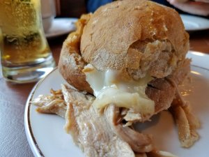 Eating pork sandwich Casa Guedes Porto
