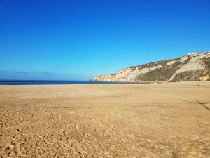 sunshine calm waves Nazare Portugal beach