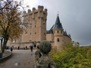 Front of Alcazar, the castle, of Segovia Spain with day trip tourists walking inside
