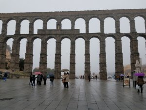 Roman Aqueduct of Segovia from the open space of Plaza Azojuelo with day trip tourists