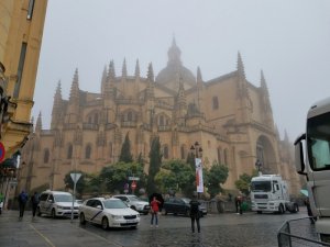 foggy day at Segovia Cathedral Spain with day trip tourists taking photos
