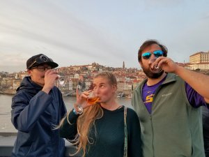 Backpackers drinking port wine in Porto Portugal