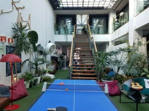 cool hostel setup with lounge and games in atrium