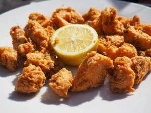plate of chunks of fried shark and a lemon in Madrid