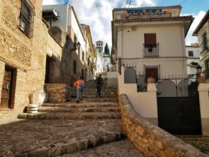 Residents walking up a steep staircase on a hill in Granada Old City