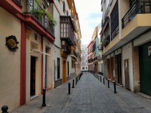 Narrow empty street in Seville Spain