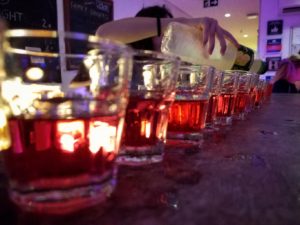 line of shots at a hostel bar during happy hour