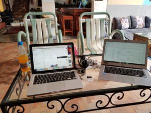 work area in a hostel common area for digital nomad