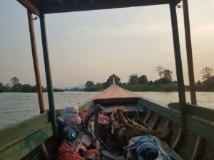 Backpacks on longtail boat in Mekong River Laos