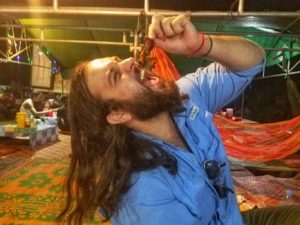 Hangry Backpacker traveling with a food allergy and fearlessly eating a frog in SE Asia