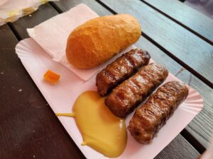 plate of mici, a Romanian food of sausages with mustard