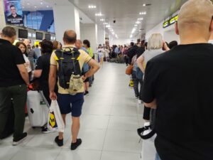 crowds of people waiting in line to check in at Bucharest OTP airport