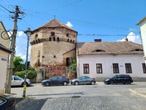 Medieval Tanners Tower next to house with Eyes of Sibiu
