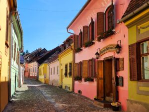 Photogenic Street of Sighisoara Romania with cobblestone streets and colorful old buildings