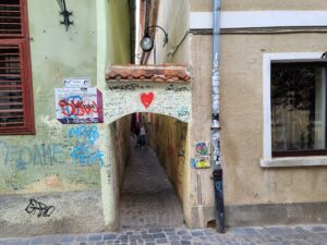 Strada Sforii narrowest street in Romania with archway and grafitti on walls