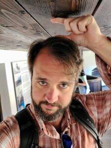 Hangry Backpacker in cramped space with low ceilings inside Bran Castle