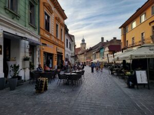 People eating outside on the streets of Brasov in the evening