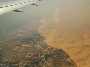 view from airplane above Egypt where the Sahara Desert abruptly ends and greenery begins