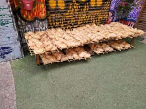 fresh bread for sale and cooling on the sidewalks of Downtown Cairo