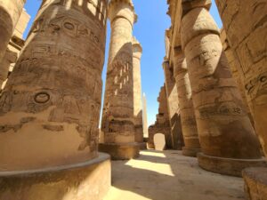 Columns with detailed reliefs and inscriptions at the Great Hypostyle Hall at Karnak Temple Complex in Egypt