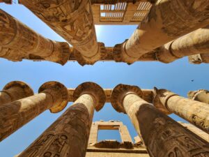 upward view of ancient columns in the Great Hypostyle Hall of Karnak Temple Complex in Luxor Egypt