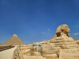 Great Sphinx and Pyramid in background in Giza Egypt travel tips